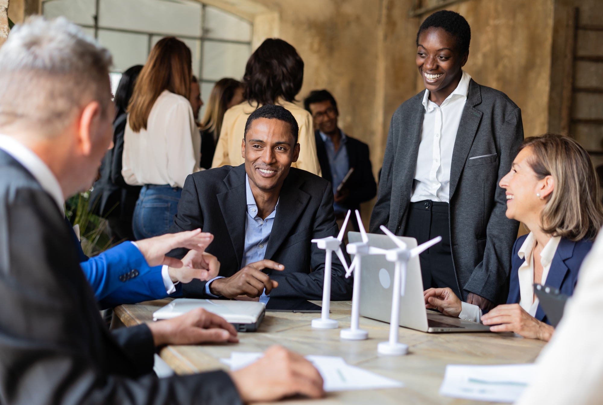 Multiracial group of savvy business professionals gather to discussing about renewable energy.